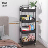 Black metal rolling cart with books and decorative items in a bedroom setting