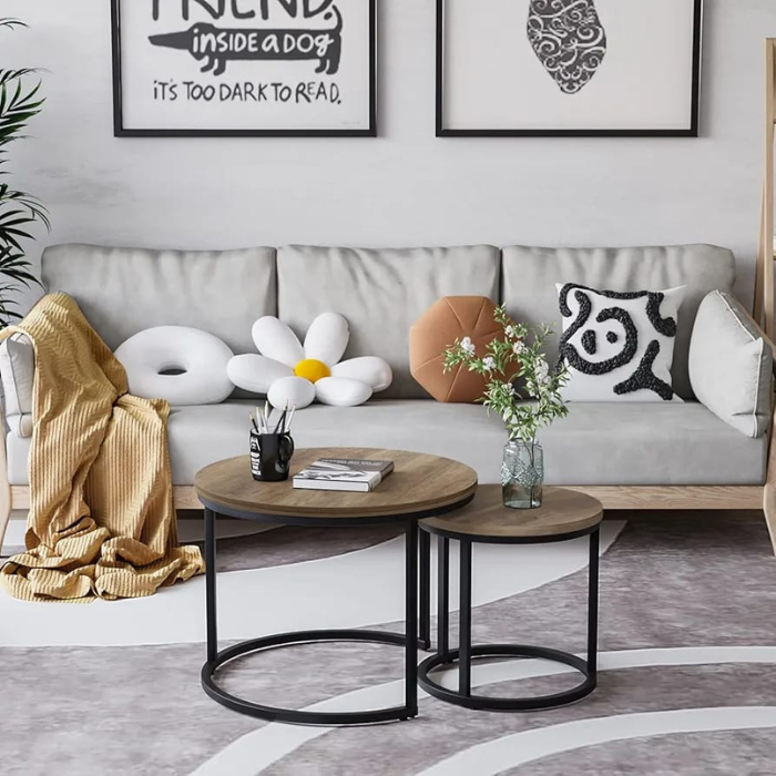 Set of 2 Arbaana wood nesting tables with round tops and circular metal frames, perfect for modern living spaces.