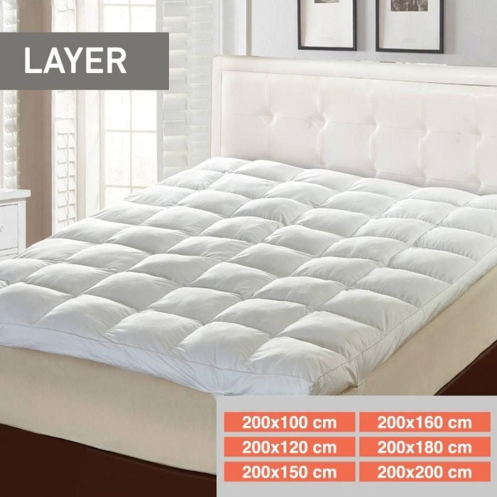 Arbaana cotton quilted mattress topper pad with flexible straps, soft and comfortable bedding layer for enhanced sleep comfort.